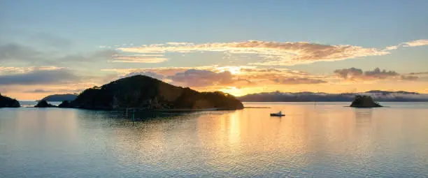 Sunrise at the Bay of Islands, an area on the east coast of the Far North District of the North Island of New Zealand. It is one of the most popular fishing, sailing and tourist destinations in the country.