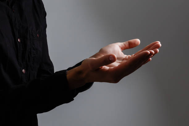 istock Man pray for something over the black background 1210304247