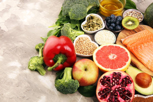istock Healthy food clean eating selection: fish, fruit, vegetable, cereal, leaf vegetable on rustic background 1210304866