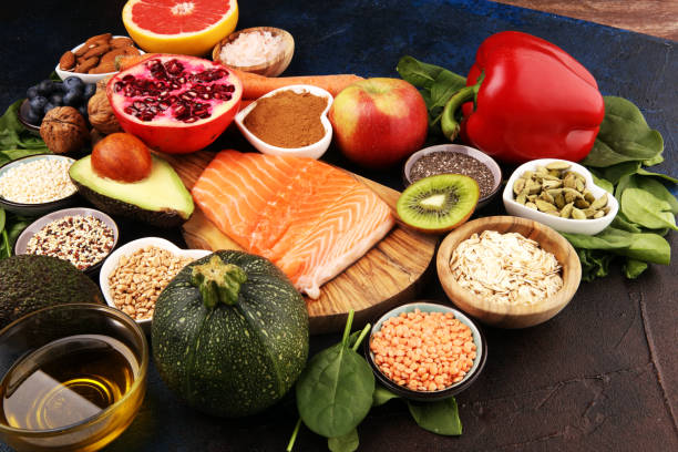 istock Healthy food clean eating selection: fish, fruit, vegetable, cereal, leaf vegetable on rustic background 1210304900