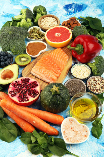 istock Healthy food clean eating selection: fish, fruit, vegetable, cereal, leaf vegetable on rustic background 1210305148