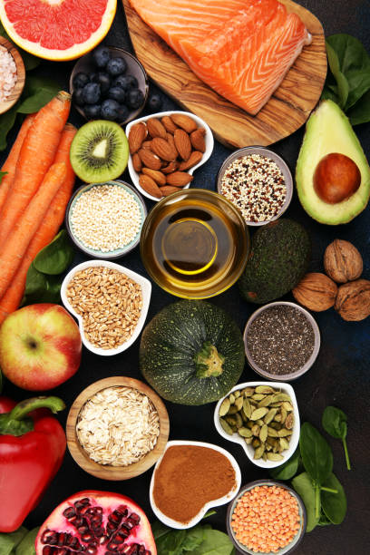 istock Healthy food clean eating selection: fish, fruit, vegetable, cereal, leaf vegetable on rustic background 1210305230
