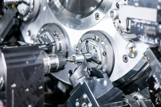 istock Mechanical industry machinery: inside of a modern multi-spindle CNC lathe machine 1210305401
