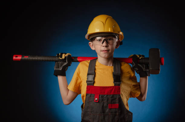 istock the child the Builder costume posing with a work tool 1210305481
