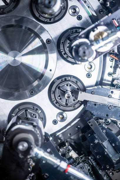istock Mechanical industry machinery: inside of a modern multi-spindle CNC lathe machine 1210305569