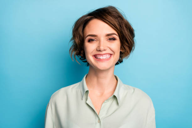 Closeup photo of attractive business lady short bob hairstyle smiling beaming good mood responsible person wear casual formalwear green shirt isolated blue color background Closeup photo of attractive business lady short bob hairstyle smiling beaming, good mood responsible person wear casual formalwear green shirt isolated blue color background bob good stock pictures, royalty-free photos & images