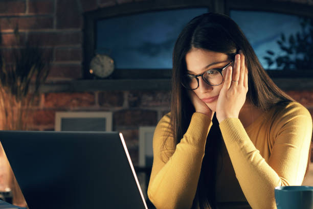 istock Tired woman at home with headache 1210309118