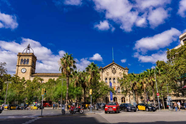 Unidentified people by University of Barcelona building in Spain. This historic building was built between 1863-1882 by Elies Rogent.