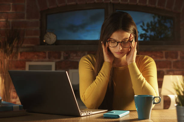 istock Tired woman at home with headache 1210309594