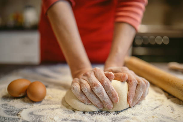 istock Woman preparing dough for bread 1210310300