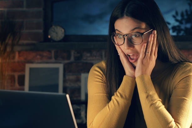 istock Surprised woman social networking with her laptop 1210310337