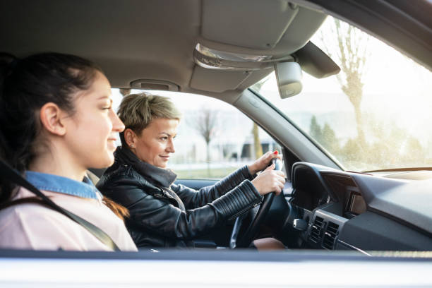 istock Mother and daughter together in car 1210310344