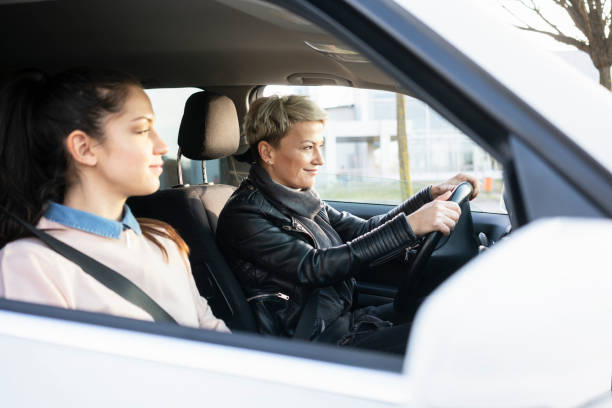 istock Mother and daughter together in car 1210310430