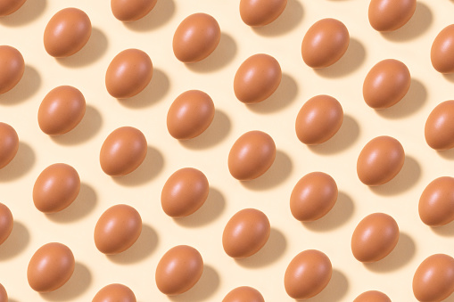 Eggs in a row on pink background