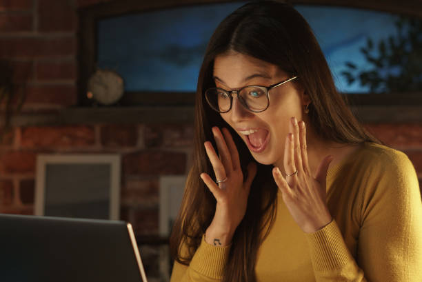 istock Surprised woman social networking with her laptop 1210310455