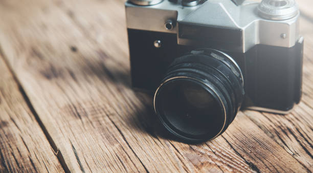 istock vintage camera on the wooden table 1210310579