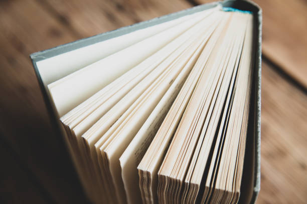 istock books page on the wooden desk background 1210310846