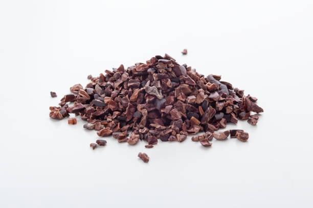 Cacao nibs Cacao nibs on white background nib stock pictures, royalty-free photos & images