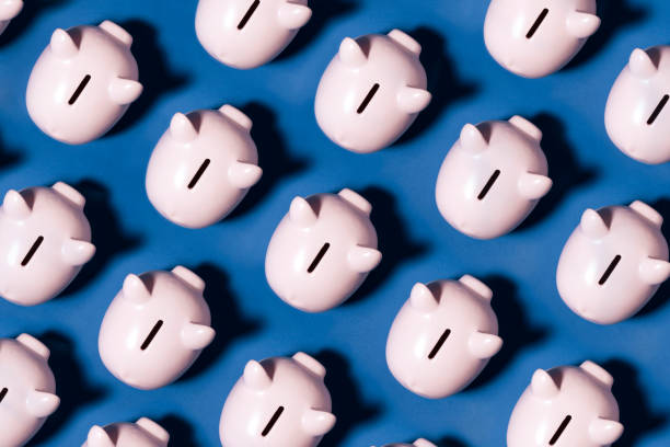 istock Piggy Bank on Blue Background 1210311043