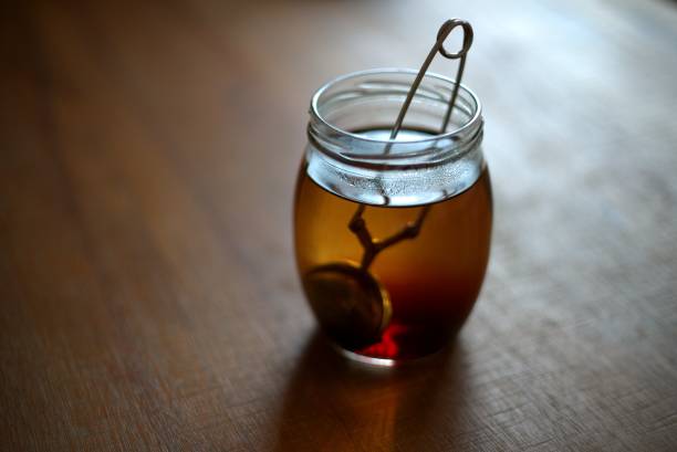 Tea in a glass jar on table stock photo