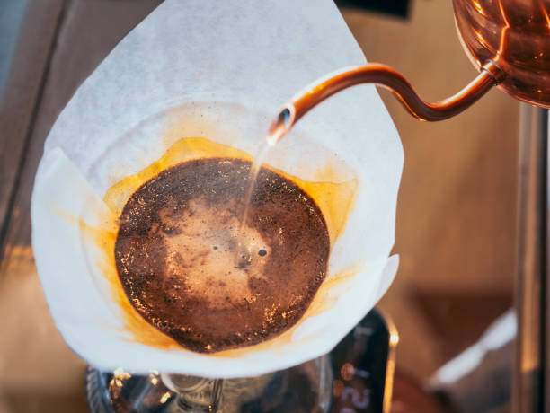 istock Hand drip coffee Barista pouring water on coffee ground with filter Cafe restaurant 1210314467