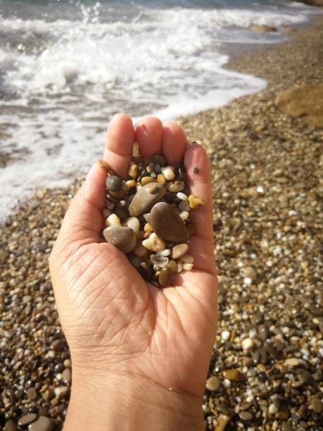 istock A man's hand holds a handful of stones 1210314866