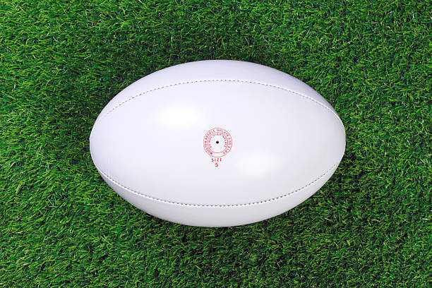 istock White rugby ball on green grass 121031578