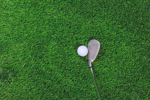 istock Golf ball and iron club on grass 121031599