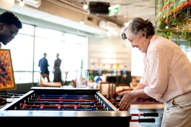 istock Business colleagues playing foosball at coworking 1210316403