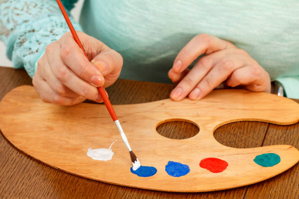 istock An artist mixing paints on the palette 1210318175