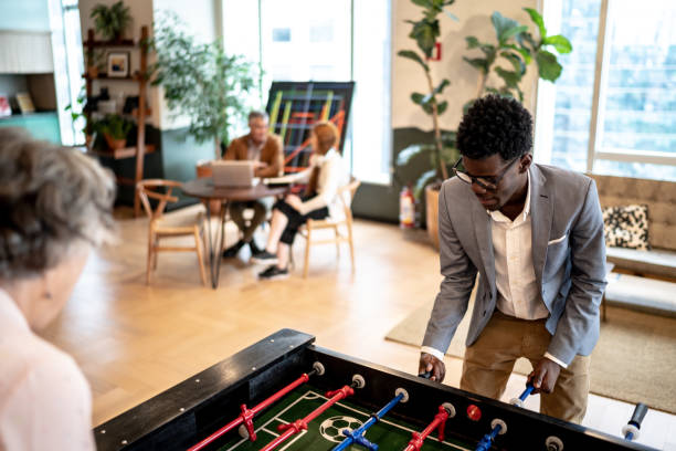 istock Business colleagues playing foosball at coworking 1210318332