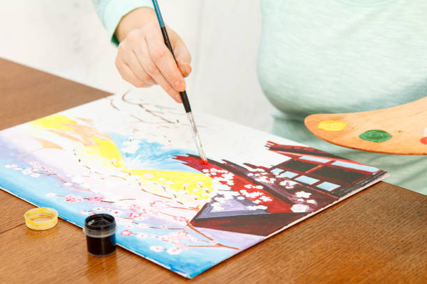 istock Woman's hand painting Japanese landscape 1210318498