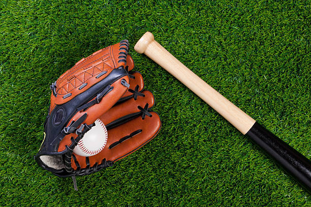 istock Baseball glove bat and ball on grass 121031873