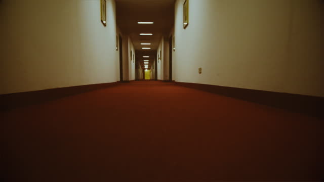 POV perspective into a dark hotel corridor: spooky themes