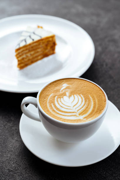 istock cup of coffee and cake on black stone background 1210322504