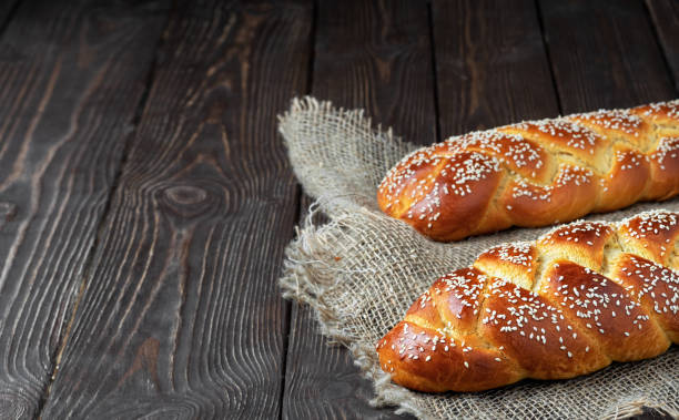 istock Freshly baked Easter challah bread on a background of coarse cloth. lose up. copy space for text. 1210322638
