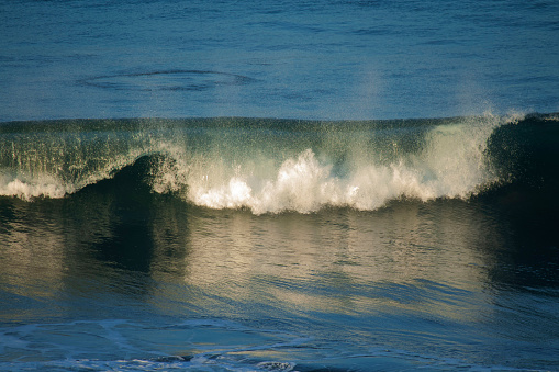 Surfing wave with blue and green water