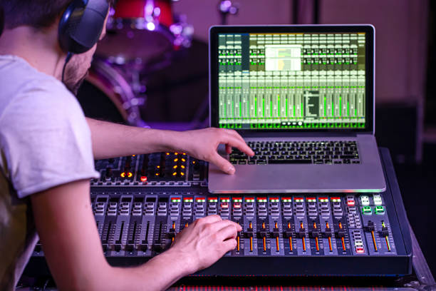 istock Digital mixer in a recording Studio , with a computer for recording music. On the background of the sound engineer at work. 1210323434