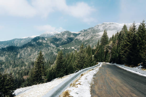 istock Road Amidst Snowcapped Mountains Against Sky 1210324940