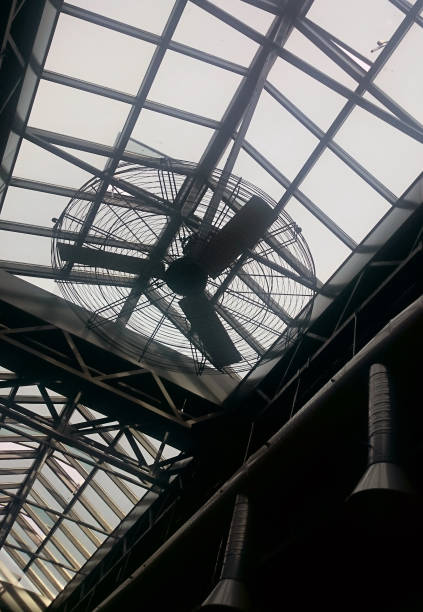 istock A big circular ventilator hanging down from a glass skylight. 1210326107