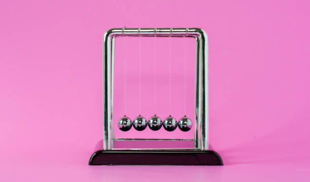 istock Newton's cradle physics concepts for action and reaction or cause and effect On the pink background 1210328218