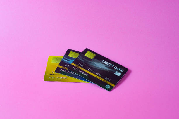 istock Credit card on pink background 1210328302