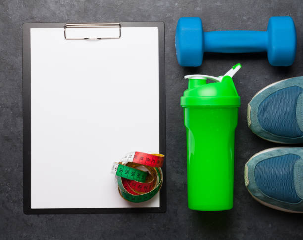 istock Fitness equipment and blank sheet for workout 1210328757
