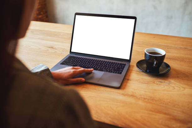 istock a woman using and touching on laptop touchpad with blank white desktop screen with coffee cup on wooden table 1210331569