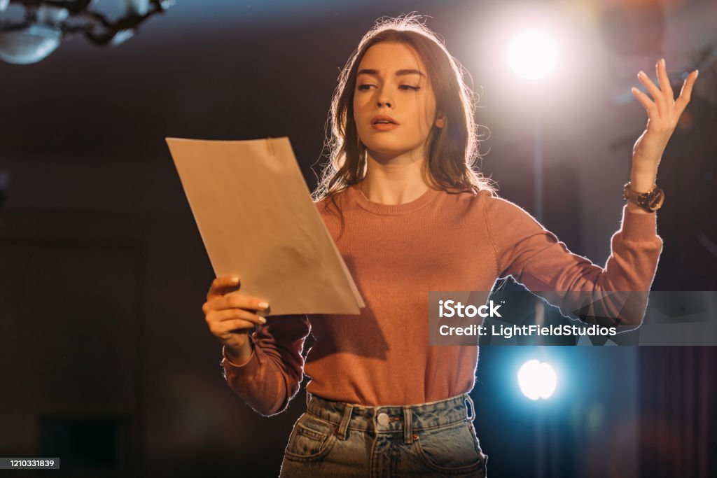 young actress reading scenario on stage in theatre Theatrical Performance Stock Photo