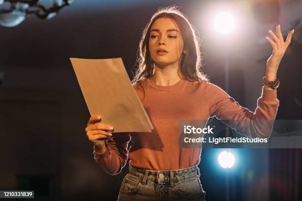 Young Actress Reading Scenario On Stage In Theatre Stock Photo - Download Image Now - Theatrical Performance, Stage Theater, Acting - Performance