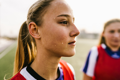 Photo of a teenage girl, soccer player, on a court