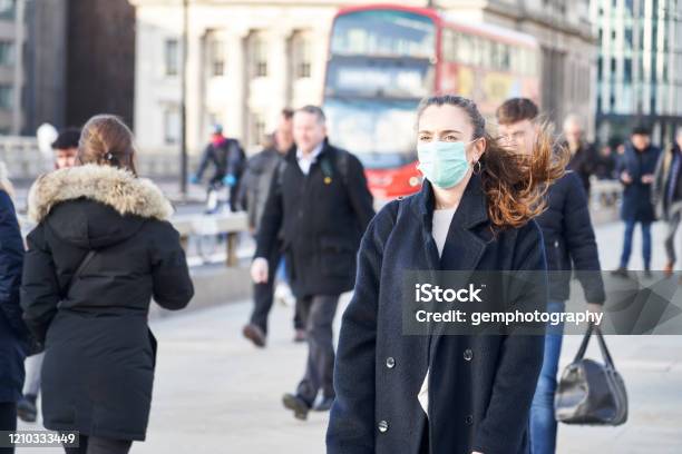 Young Woman Wearing Face Mask While Walking In The Streets Of London Stock Photo - Download Image Now