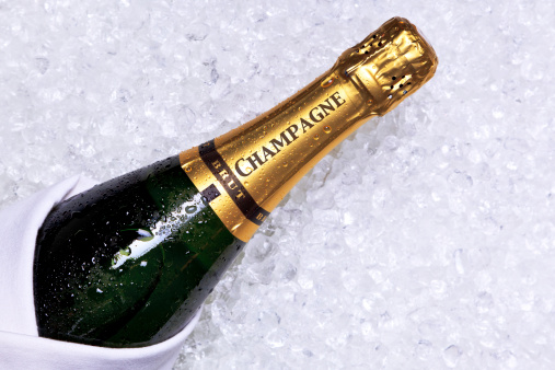 Photo of a bottle of Champagne on crushed ice.