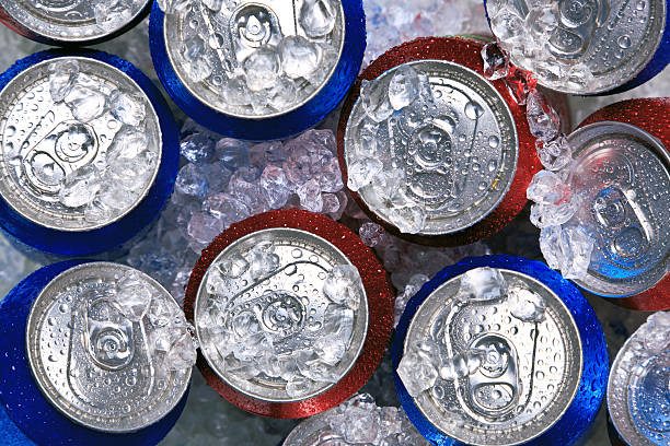 cans of drink on crushed ice - koude dranken stockfoto's en -beelden